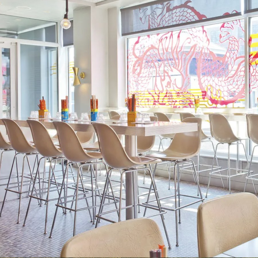 Bar seating and a mural inside a restaurant