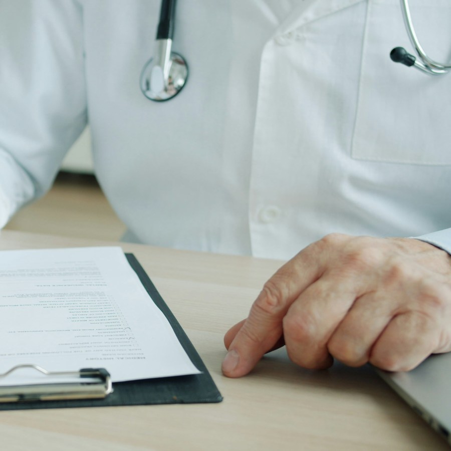 A doctor reviewing a medical history checklist with a patient